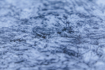 Ice texture, interesting frozen lake patterns, naturally created forms. Frozen river's water in the winter in mount Vitosha, near Sofia, Bulgaria. Ice Age climate changes.