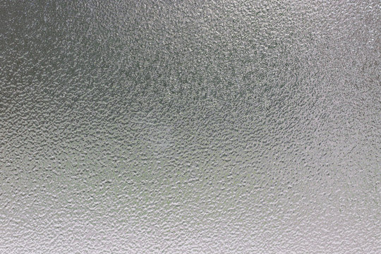 Frosted glass texture photo with blurred background.