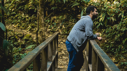 Man enjoying and relaxing in the forest standing in the wood