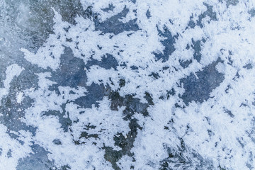 Ice texture, interesting frozen lake patterns, naturally created forms. Frozen river's water in the winter in mount Vitosha, near Sofia, Bulgaria. Ice Age climate changes.