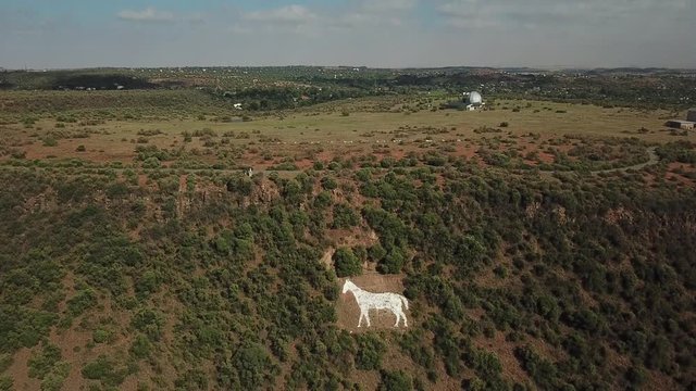 4K summer day aerial video Bloemfontein Naval Hill Planetarium Boyden Observatory, White Horse sculpture of Anglo Boer War days. Hill forms part of Franklin Game Reserve in Free State, South Africa