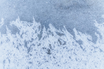 Ice texture, interesting frozen lake patterns, naturally created forms. Frozen river's water in the winter in mount Vitosha, near Sofia, Bulgaria. Ice Age climate changes.