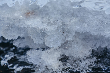 Obraz premium Ice texture, interesting frozen lake patterns, naturally created forms. Frozen river's water in the winter in mount Vitosha, near Sofia, Bulgaria. Ice Age climate changes.