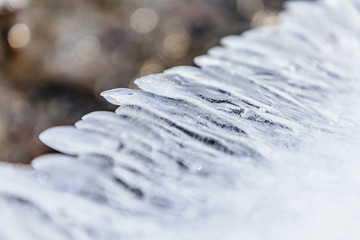 Fototapeta na wymiar Ice texture, interesting frozen lake patterns, naturally created forms. Frozen river's water in the winter in mount Vitosha, near Sofia, Bulgaria. Ice Age climate changes.