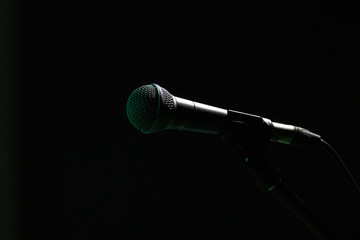 Obraz premium Isolated mic on stand. Black background.