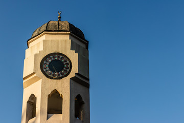 a good looking perspective shoot to a dome shaped clock tower - clean blue sky as background