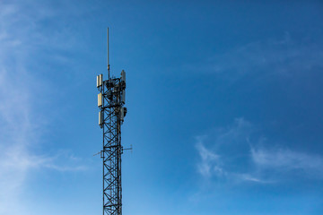 A single standard cell site tower in Canada. A steel frame tower houses electronic communications equipment. Telecommunications infrastructure