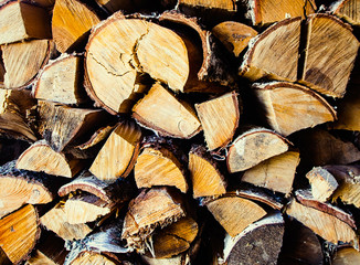 Old birch woodpile in a country house background / wallpaper.