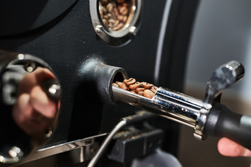 Coffee processing technology. Details of a professional coffee roasting machine. Close-up.