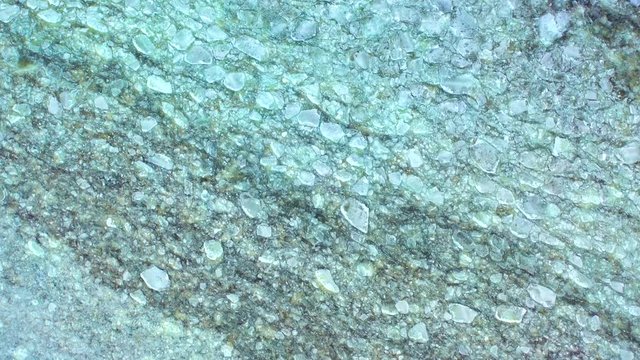 Looking down on otherworldly, textured, broken ice in Lake Michigan. The pieces you see here look small, but they are each as big as a house. Aerial view.