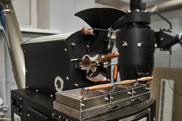 Coffee processing technology. Modern professional coffee roasting equipment. Close-up.