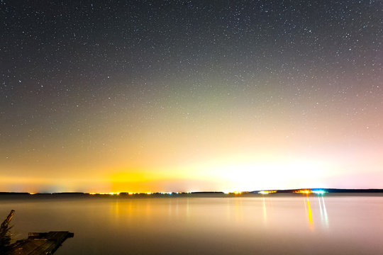 Starry sky over the lake. Starry sky background picture of stars in night sky and the Milky Way. © Ludmila