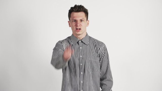 a young man of Caucasian appearance Shows the emotion of anger. unhappy. On a white background.