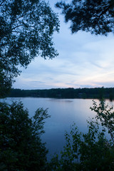 Gorgeous Sunset Sky Reflected in Lake Framed by Tree Silhouette