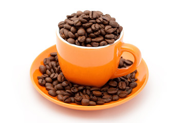 Roasted coffee beans in an orange cup