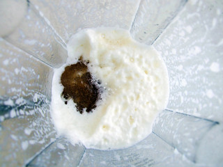 in the bowl of the blender whipped cream with coffee and sugar, top view, cooking home dessert - panna cotta