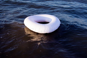 white flotation ring on blue sea, concept, safety on water, life saver