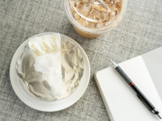 Relaxing working on cafe table with laptop notebook and a piece of cake , workplace freelance, strategies thinking