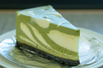 green tea cake on dish and wooden table