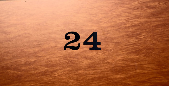 Black number 24, twenty-four, on elegant garded brown background.