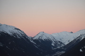 snowy mountain tops in sunset