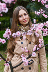 Fototapeta premium Portrait of beautiful woman with blooming flowers