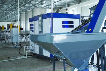 Filling line of sparkling water in pet bottle. Mini factory for bottling water.