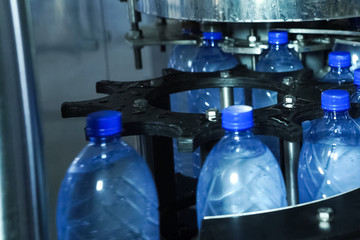 Filling line of sparkling water in pet bottle. Mini factory for