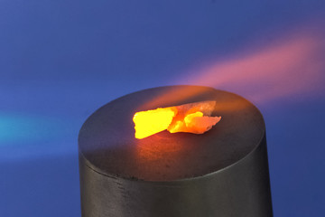 Heating the gas torch pieces of metal.