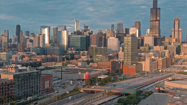Aerial: The Chicago city skyline & traffic on the 290 Freeway at sunset. Illinois, USA.