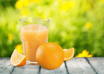 Orange juice and slices of orange fruit in glass