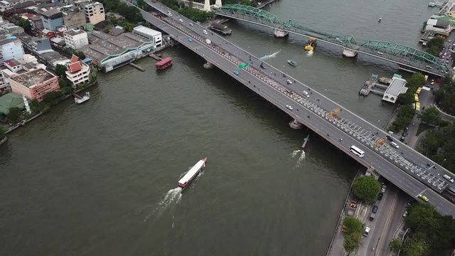 Birdseye Aerial Approaching to Bridges over Chao Phraya River, Bangkok Thailand. Traffic on and Under Phra Pokklao and Memorial Bridge
