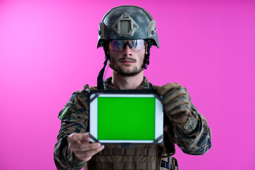 soldier showing a tablet with a blank green screen