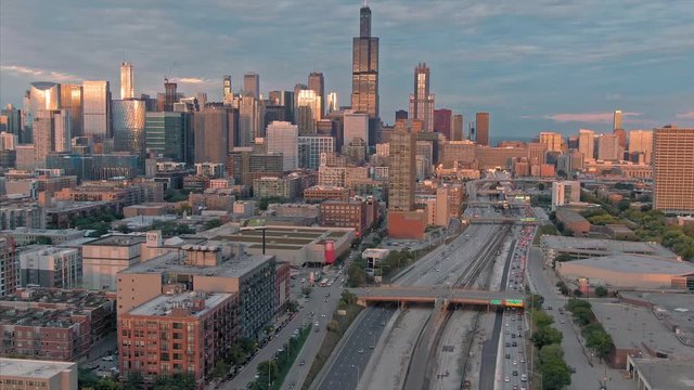 Aerial: The Chicago city skyline & traffic on the 290 Freeway at sunset. Illinois, USA.