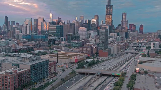Aerial: The Chicago city skyline & traffic on the 290 Freeway at sunset. Illinois, USA.