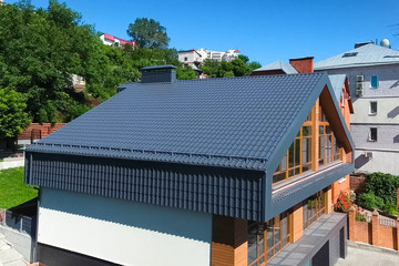 House with a gray metal roof. Corrugated metal roof and metal ro