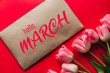 Greeting card with the inscription Hello March. Bouquet of pink Tulip flowers © alexkoral