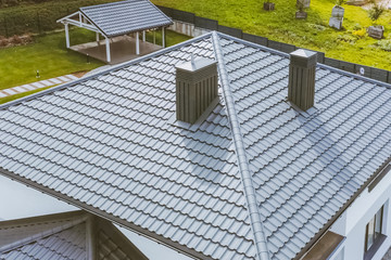 House with a gray metal roof. Corrugated metal roof and metal ro