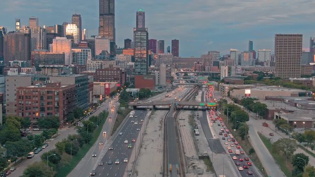 Aerial: The Chicago city skyline & traffic on the 290 Freeway at sunset. Illinois, USA.