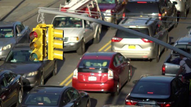 New York City traffic jam, focus on intersection light with traffic out of focus. 