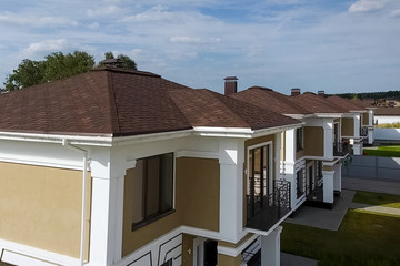 Bituminous tile for a roof. House with a roof from a bituminous