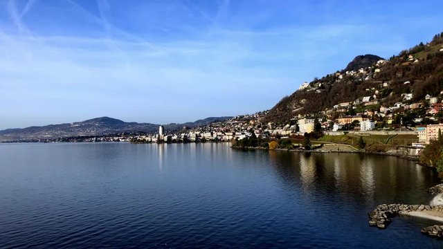 Slow pan of Lake Geneva from Chillon Castle showing the shoreline city of Veytaux