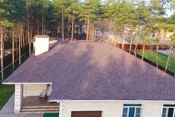 Bituminous tile for a roof. House with a roof from a bituminous