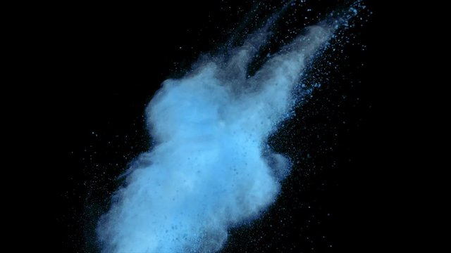 Realistic blue powder explosion on black background. Slow motion movement with acceleration in vertical motion