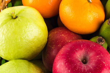 Assortment of exotic fruits ( guava and orange and red apple )on  background fruit health food