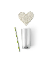 Creative composition with glass, straw and rice in heart shape isolated on white background