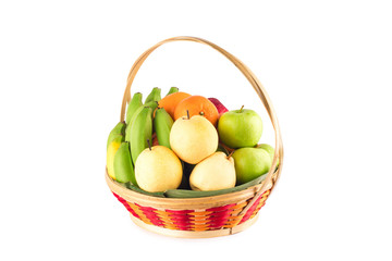 composition assorted fresh fruits such as orange, Chinese pear, banana, red apple and green applein  bamboo wicker basket on white background fruit health food isolated