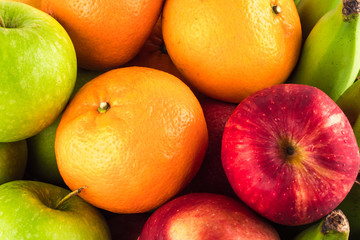 green apple and orange and red apple and banana are mixed tasty fruit composition on  background fruit health food