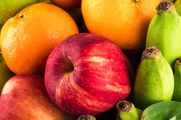 Seasonal organic raw fruit  ( red apple and banana and orange ) on  background fruit health food