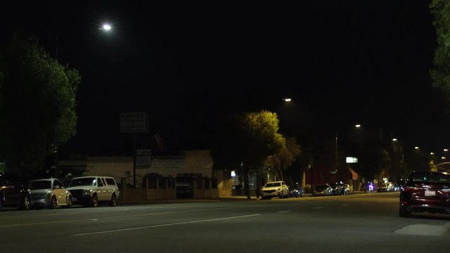 Nigh time Street with Traffic in the Suburbs.